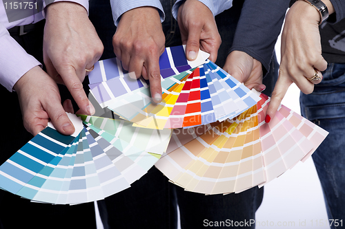 Image of Hands pointing to color samples