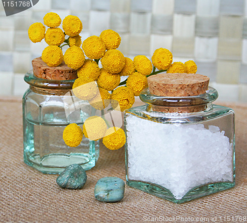 Image of Bottles of essential oil and sea salt in spa composition 
