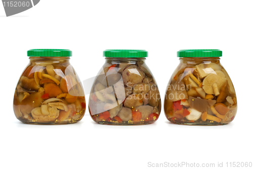 Image of Three glass jars with marinated mushrooms