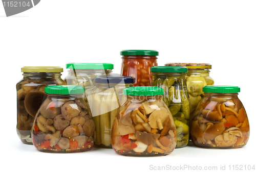 Image of Glass jars with marinated vegetables and mushrooms