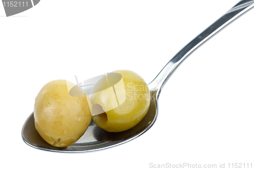 Image of Two marinated pitted green olives in the small metal spoon