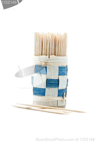 Image of Bundle of wooden toothpicks and some toothpicks near
