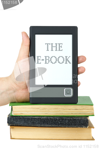 Image of Hand put e-book reader on top of classic paper books