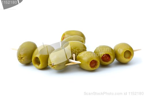 Image of Some olives stuffed with pepper on a wooden toothpicks