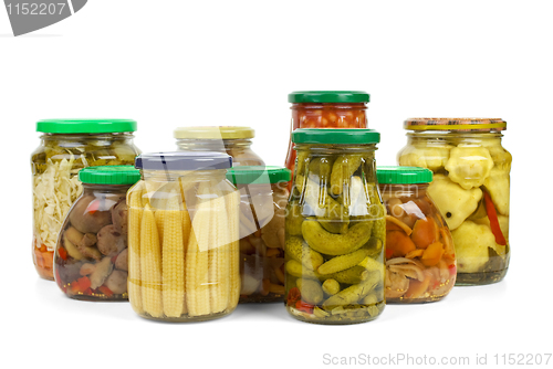 Image of Glass jars with marinated vegetables and mushrooms