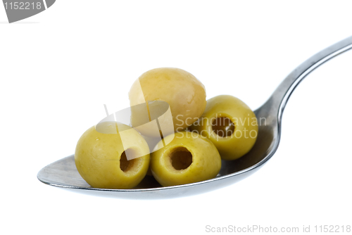 Image of Five marinated pitted green olives in the metal spoon