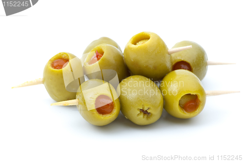 Image of Some olives stuffed with pepper on a wooden toothpicks