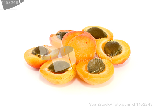 Image of One whole and six apricot halves with kernels lying in form of flower