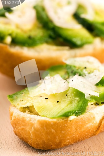 Image of Sandwich with avocado on a wooden board 