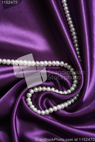 Image of White pearls on a lilac silk 