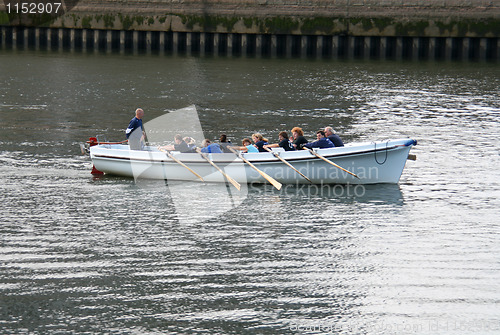 Image of People in a rowboat.