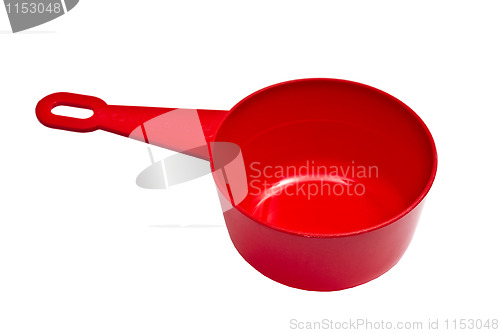 Image of Red plastic measuring cup isolated on white