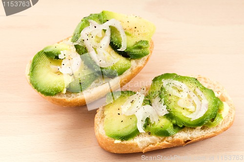 Image of Sandwich with avocado on a wooden board 