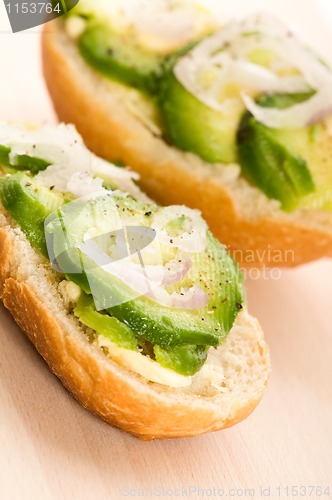 Image of Sandwich with avocado on a wooden board 