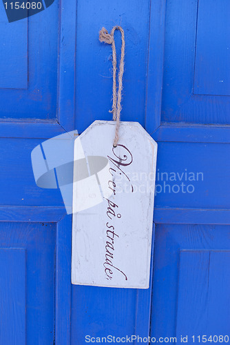 Image of sign on blue door
