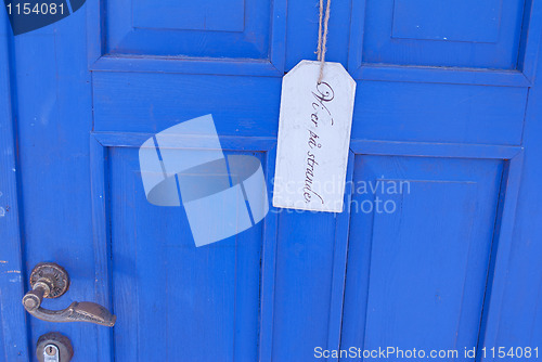 Image of sign on blue door