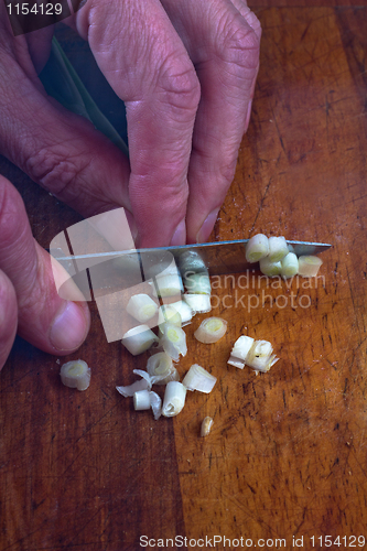 Image of Close-Up Of Hands Chopping Onions