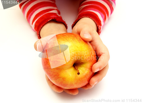 Image of child is holding fresh apple