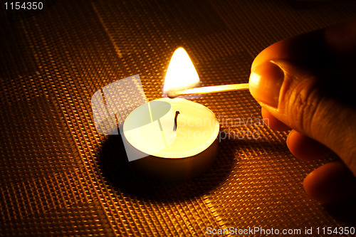 Image of Candle ignition with match