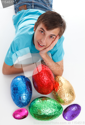 Image of Boy with a bunch of chocolate easter eggs