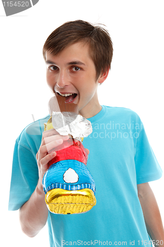 Image of Smiling happy child eating chocolate easter