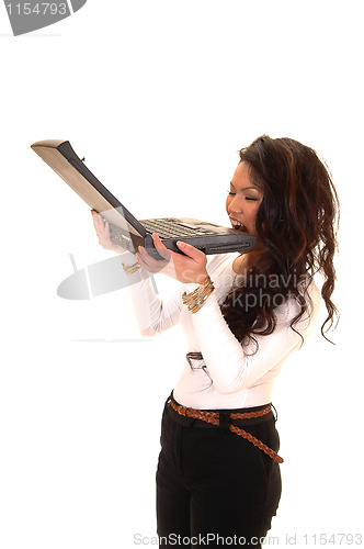 Image of Girl bite laptop.