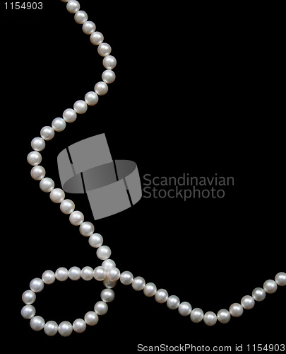 Image of White pearls on the black velvet  background