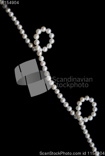 Image of White pearls on the black velvet  background