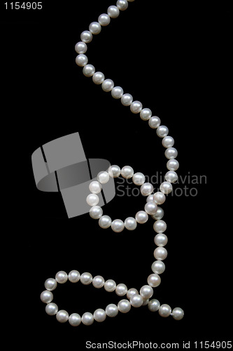 Image of White pearls on the black velvet  background