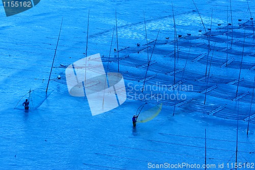 Image of Fishermen working near the seaweed farm