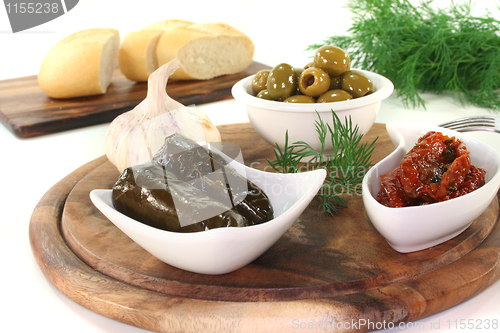 Image of Olives, stuffed vine leaves and dried tomatoes
