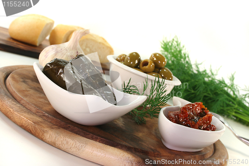 Image of Olives, stuffed vine leaves and dried tomatoes