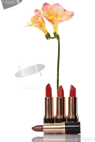 Image of glamor red shiny lipstick and yellow flower