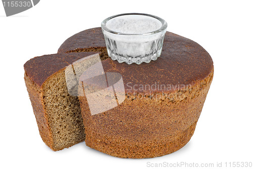 Image of Cut loaf of round rye bread and salt jar