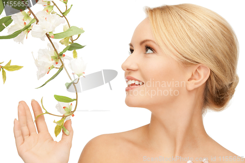 Image of beautiful woman with orchid flower