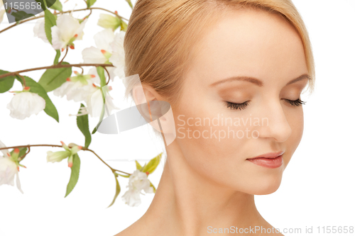 Image of beautiful woman with orchid flower