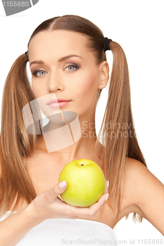 Image of young beautiful woman with green apple