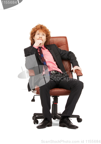 Image of young businessman sitting in chair