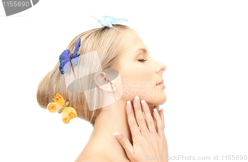 Image of beautiful woman with butterfly in hair