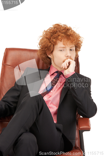 Image of young businessman sitting in chair