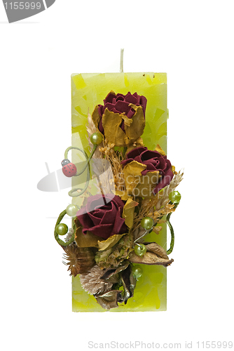 Image of Large green candle with the flower decoration