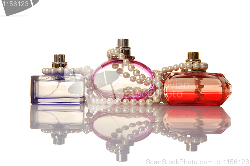 Image of Perfume in a glass bottles and pearl beeds