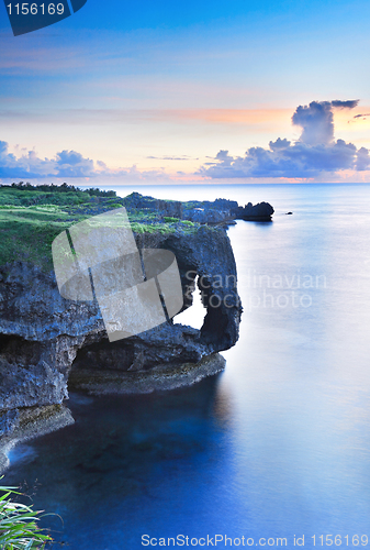Image of sunset on the rocks , in Okinawa , Manzamo