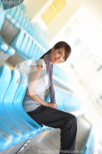 Image of sporty girl sit in sport arena
