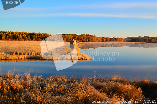 Image of Sunrise landscape of lake in grassland