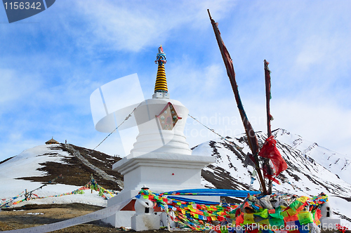 Image of White Tibetan pagoda near snow mountain