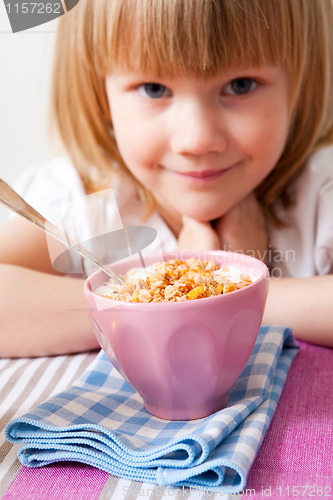 Image of Little girl in breakfast table