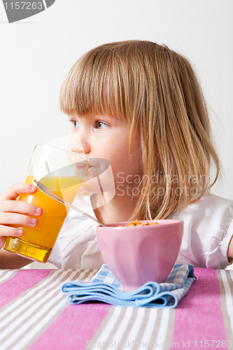 Image of Little girl eating breakfast