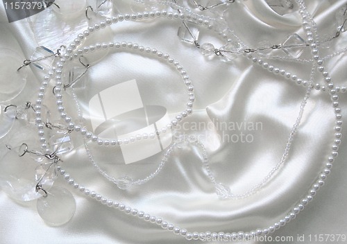 Image of White pearls and nacreous beeds on white silk 