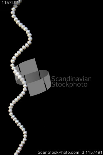 Image of White pearls on the black silk